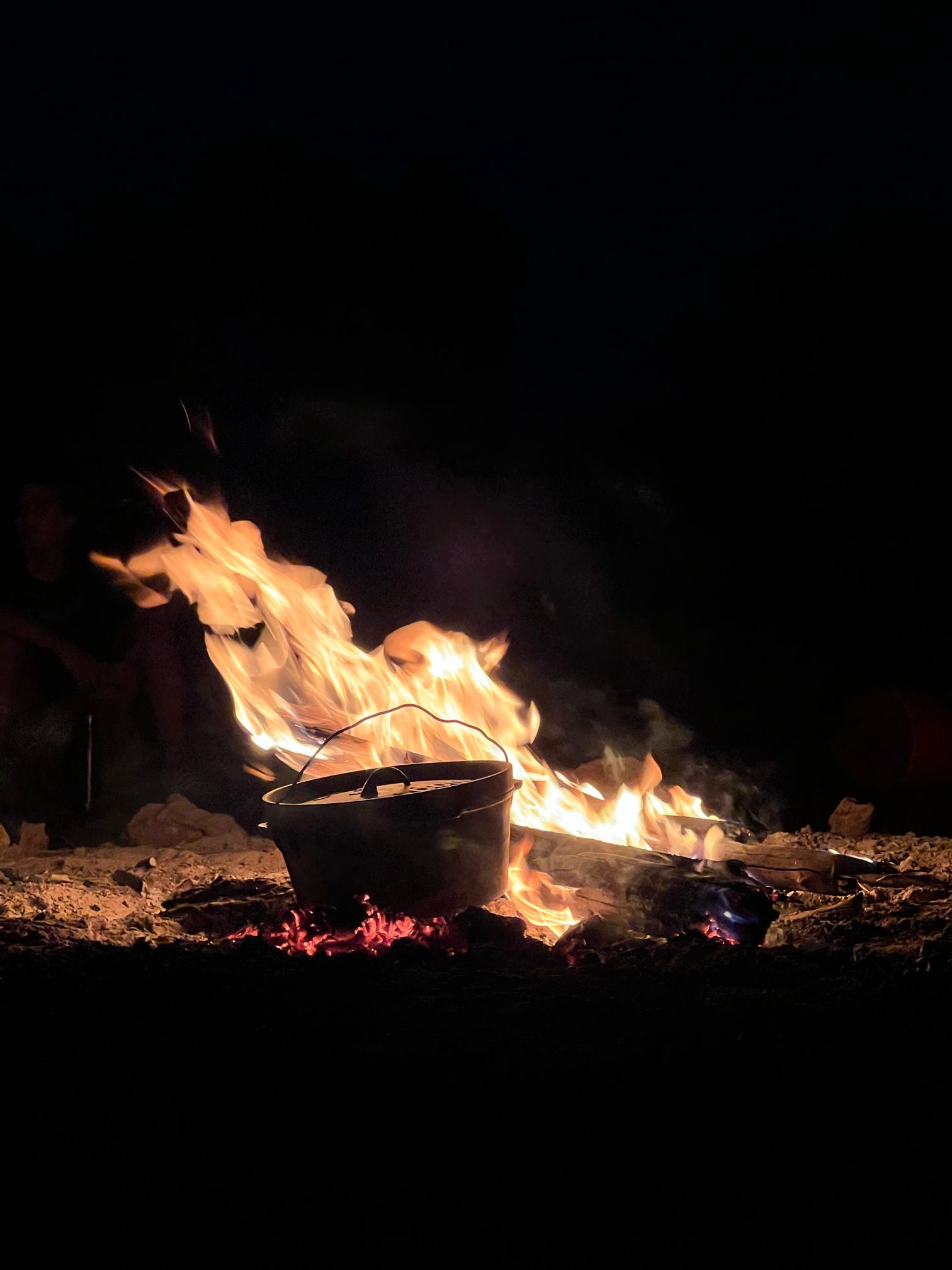 A traditional pot cooking over a campfire, capturing the essence of outback dining during a Mulgas Adventures tour.