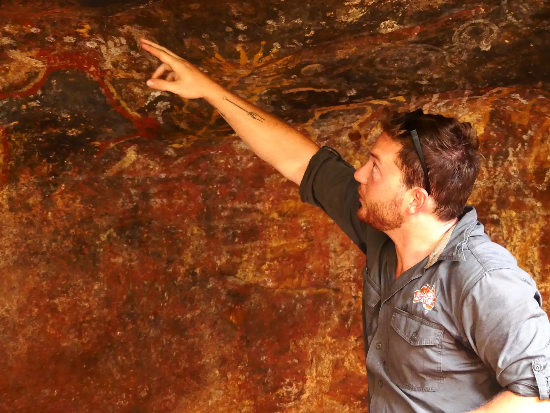 Mulgas Adventures tour guide Alex explains the significance of ancient rock art in the Australian outback, highlighting the rich cultural heritage of the region.