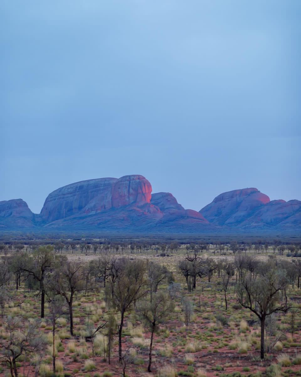 Experience the quiet magnificence of Kata Tjuta, even on a cloudy day, as part of your journey with Mulgas Adventures. Photo credit: John Klug. Instagram: @john_klug